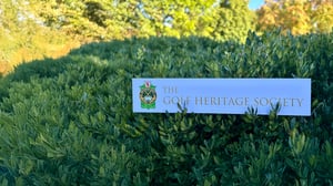 The Golf Heritage Society logo displayed in a green landscape, symbolizing the preservation and celebration of golf’s history and traditions.