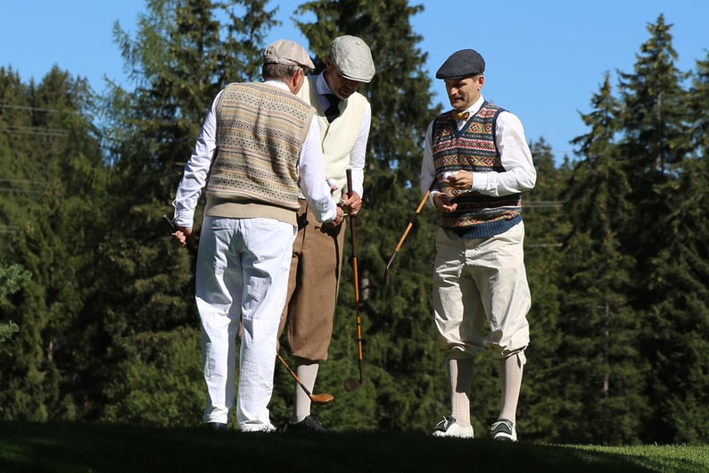 Hickory golfers in traditional attire practising